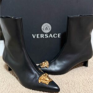 Brand new never worn Versace Black Heeled Boots with Gold Lion Accent